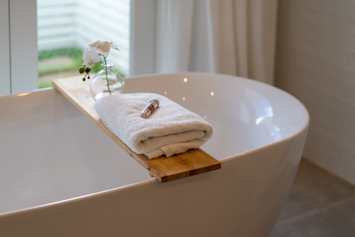 image of a nicely remodeled bathroom and a new bathtub as the focus.